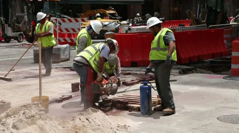 Workman using masonry saw to cut paving bricks Stock Footage 24651504