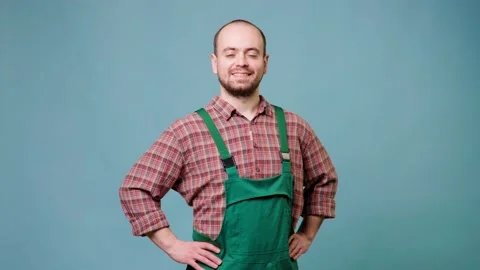 Workman young man arms on hips is happy and looking at camera. Stock Footage 229581031