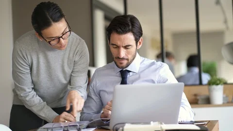 Workmates working on project in office Stock Footage 100661194
