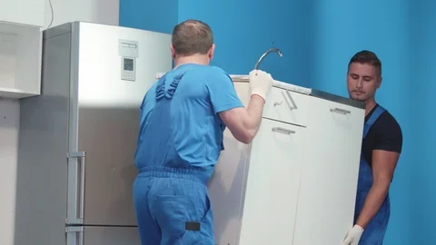 Workmen bring a kitchen stand. Stock Footage 116538830