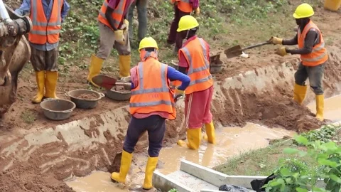 Workmen clear sand out of a Gutter CloseUp Stock Footage 75898167