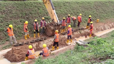 Workmen clear sand out of a Gutter Stock Footage 75898229