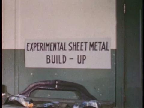Workmen construct test cars in a factory in the 1940s. Stock Footage 75294339