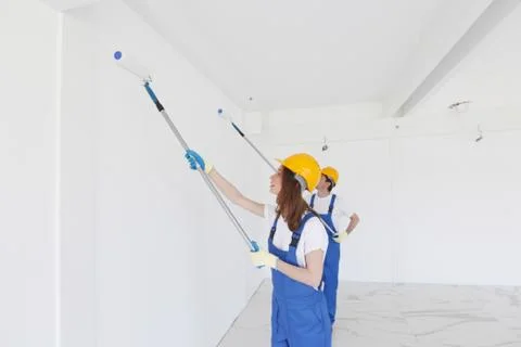 Workmen painting wall Stock Photos