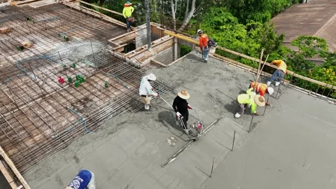 Workmen pouring screed during construction of high-rise residential building Stock Footage 245959802