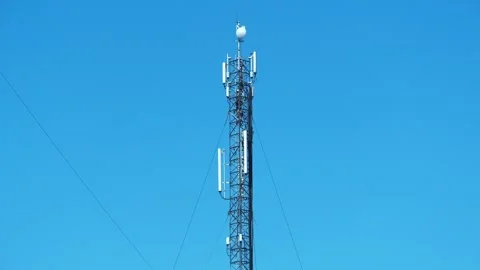 Workmen service a cell tower. Workers repair cell tower. Workers on cell tower Stock Footage 323084495