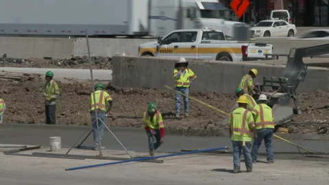 Workmen smooth new concrete at construction site, 4K. Stock Footage 151606619