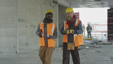 Workmen with Tools Walking along Construction Site Stock Footage 258908473