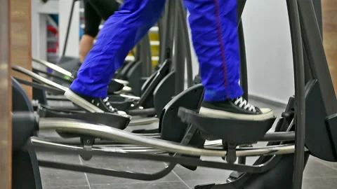 Workout. Exercising on the adaptive motor trainer machine Stock Footage 85529219