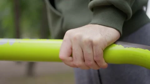 Workout in the fall, man in hoodie, on parallel bars, slow motion, close up hand 스톡 동영상 217931450