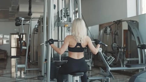 Workout with girl using exercise machine in fitness center Stock Footage 302115900