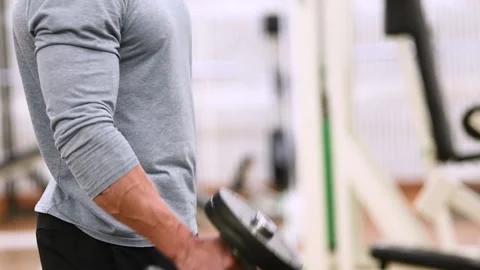 Workout at gym. Man doing exercises with dumbbell Stock Footage 131397581