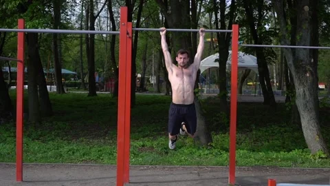 Workout, man performs handstand gymnastic element, street training and physical Stock Footage 130818702