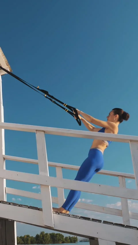 Workout outdoors. suspension straps. workout with straps. Athletic young woman Stock Footage 315755817