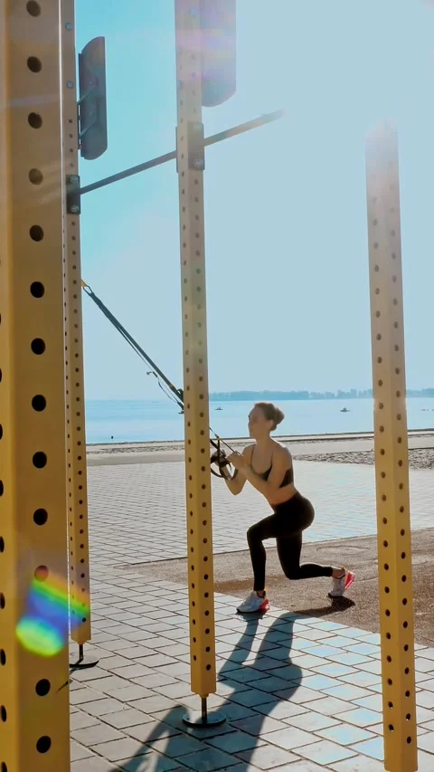 Workout outdoors. suspension straps. workout with straps. Athletic young woman Stock Footage 317701805
