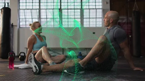 Workout partners cooling on mat, chat sparking green effect swirling during Stock Footage 333169921