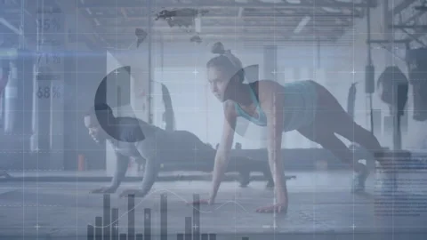 Workout partners performing push-ups in gym with animated data graphics 動画素材 307946425