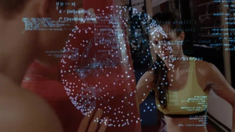 Workout partners punching bag in dim gym, showing technology overlay with Python Stock Footage 330251450