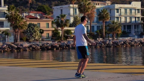 Workout on the pier, a man is training with a rope Stock Footage 126940650