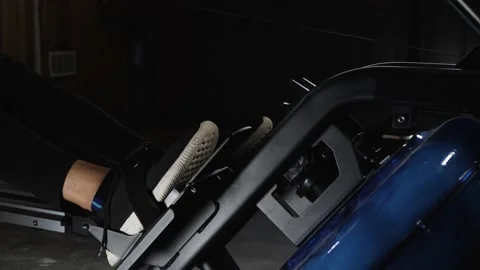 Workout on rowing machine Stockbeeldmateriaal 160040504