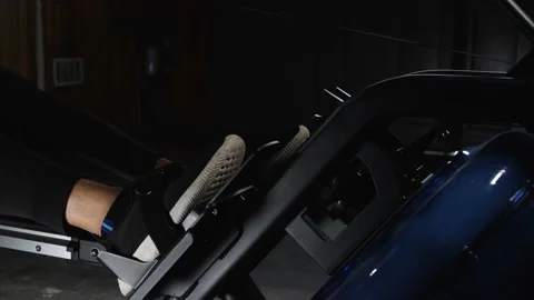 Workout on rowing machine Stockbeeldmateriaal 160040815