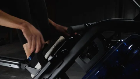 Workout on rowing machine Stockbeeldmateriaal 160040897