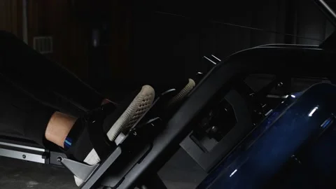 Workout on rowing machine Stockbeeldmateriaal 160041574