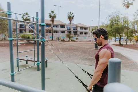 Workout session outdoors, a man is training the upper part body Stock Photos
