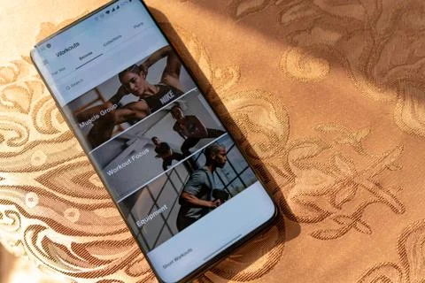 Workout sets displayed on a smartphone screen. Sport app training at home Stock Photos