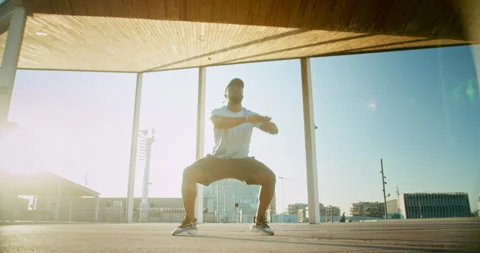 Workout squats body weight exercises morning outdoors urban landscape motivated Stock Footage 140740516
