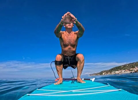 Workout on stand up paddle board Stock Photos