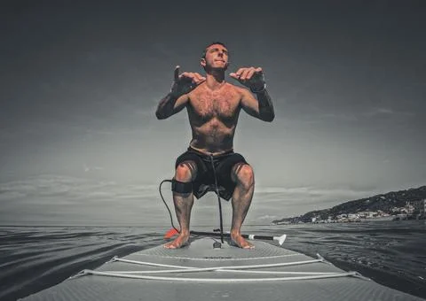 Workout on a stand up paddle board Stock-Fotos