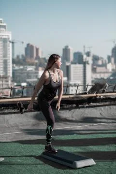 Workout with step platform on the roof of the building. Stock Photos