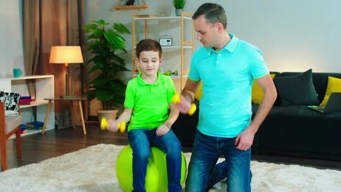 Workout time for dad and his cute son they together doing exercises to make Stock Footage 146189680