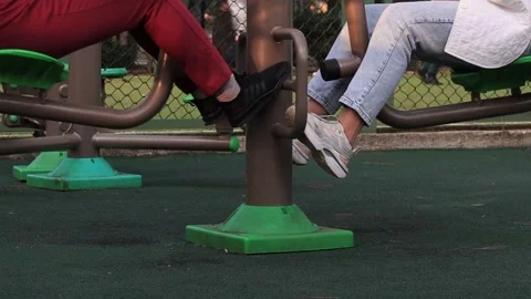 Workout women's legs on outdoor exercise machines, outdoor sports Stock Footage 290165646
