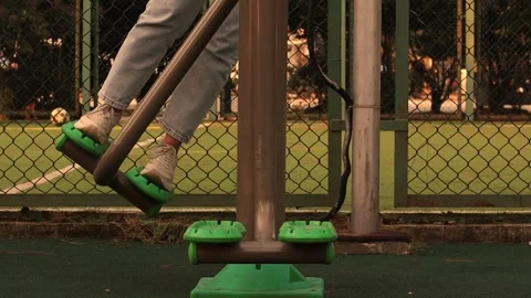 Workout women's legs on outdoor exercise machines, outdoor sports Stock Footage 290165671