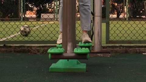 Workout women's legs on outdoor exercise machines, outdoor sports Stock Footage 290165708