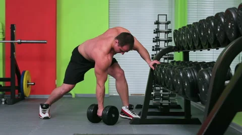 Workout for young bodybuilder. One Arm Dumbbell Row Stock Footage 58051699