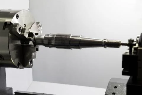 Workpiece cutting in a CNC  lathe machine : Side view Stock Photos