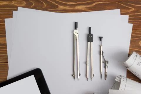 Workplace of architect - Architectural project, plan, blueprint rolls and tablet Stock Photos