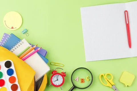 Workplace with a backpack and school supplies. Stock Photos