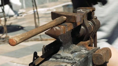 Workplace blacksmith. Anvil, hammers, tongs. Forge on the street. Close-up. 動画素材 110836759
