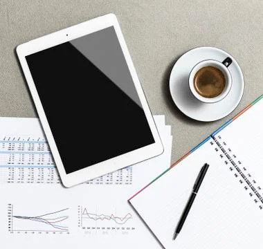 Workplace with blank digital tablet, cafe, notebook and pen on table Stock Photos