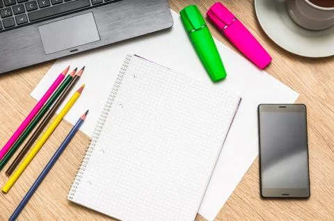 Workplace with blank white notepad, mobile phone, paper, pencils, laptop and  Foto stock