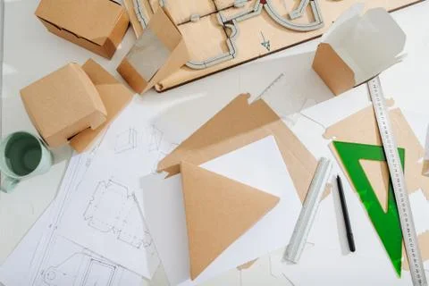 Workplace of a box maker, sheets, tools and scematics all across Foto stock