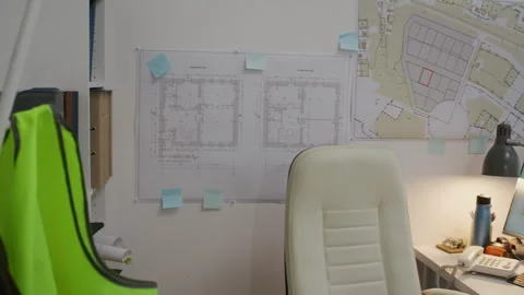 Workplace with Computer and Blueprints on Wall in Construction Office Stock Footage 329618950