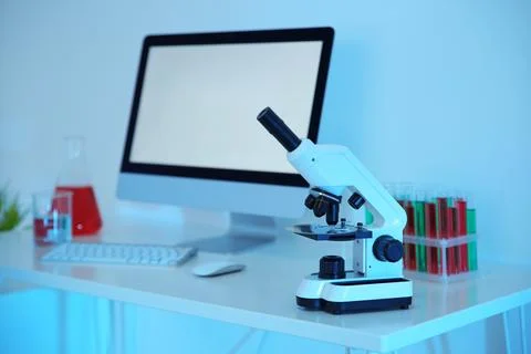 Workplace with computer and microscope for medical student in scientific labo Stock Photos