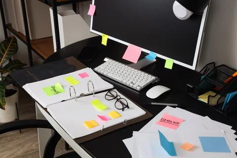 Workplace with computer, folder and sticky notes in office Stock Photos