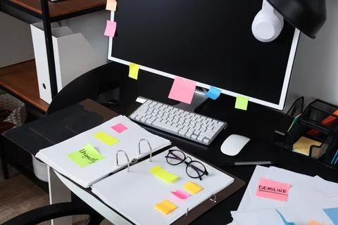 Workplace with computer, folder and sticky notes in office Stock Photos