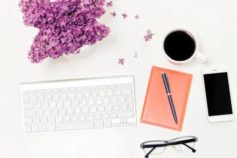 Workplace computer keyboard mobile phone cup coffee notebook lilac Stock Photos